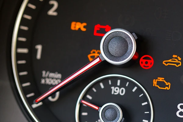 A close up look at a car's dashboard and its various illuminated lights